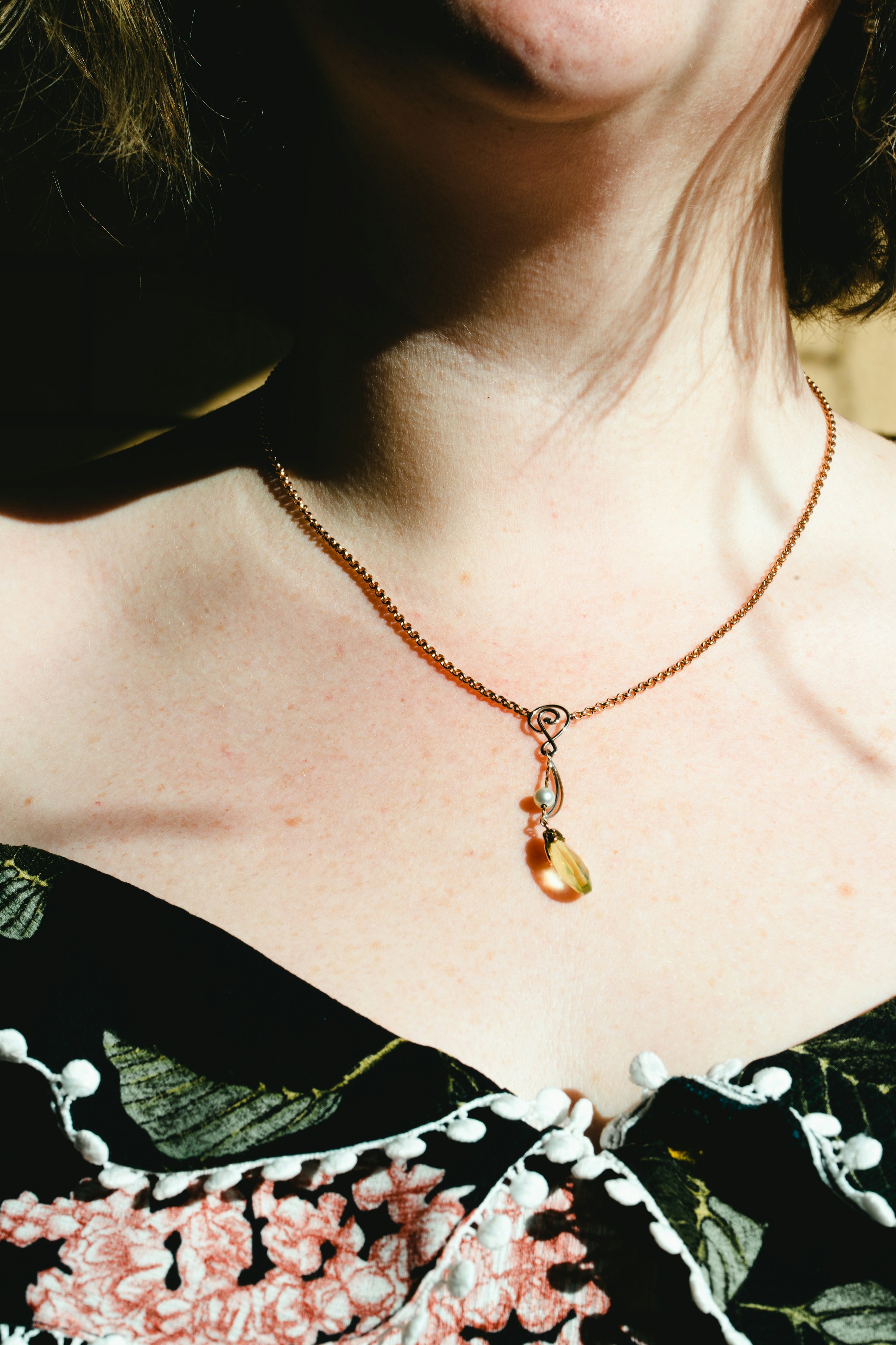 A model wearing delicate gold jewelry for Calytris